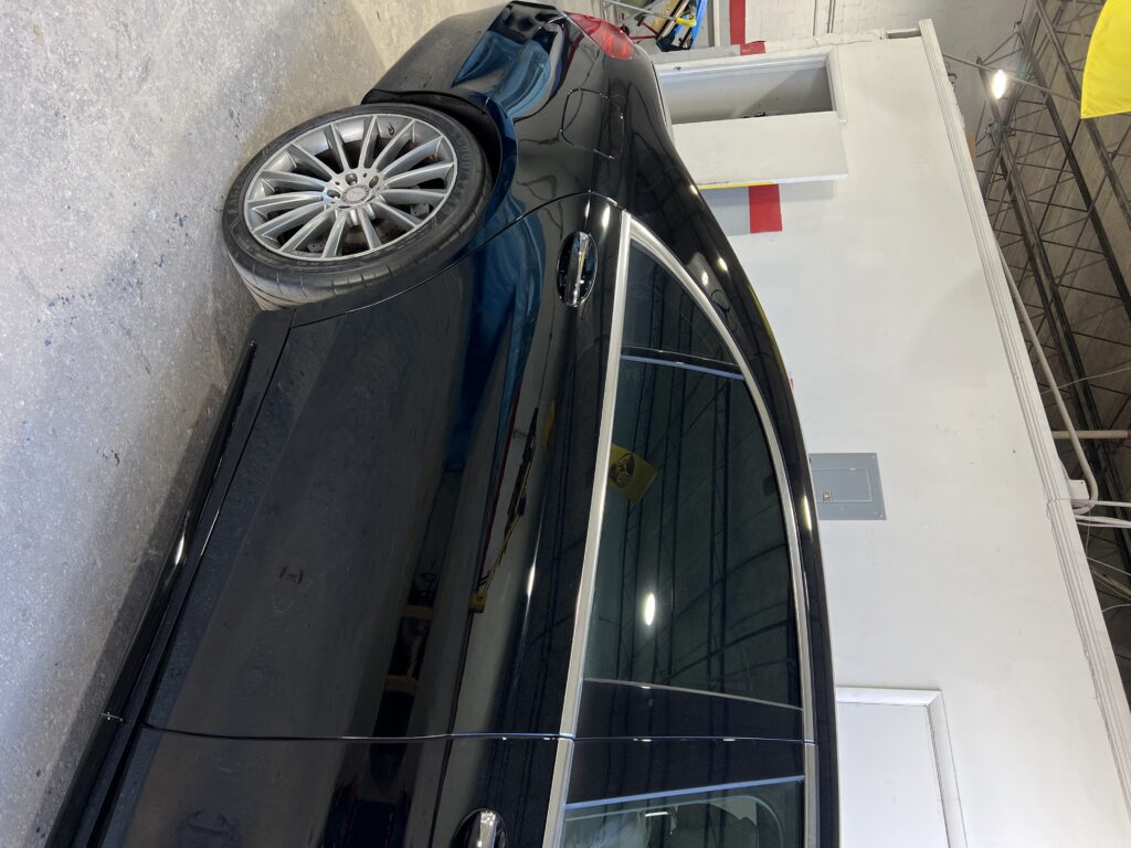 Vehicle after side collision repair with smooth body and fresh paint finish