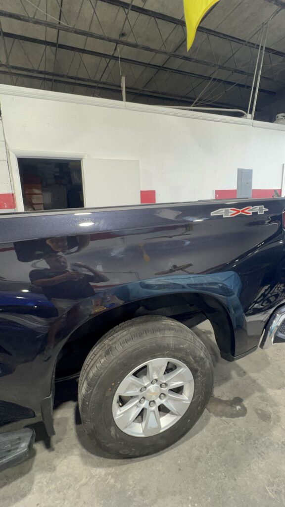 Vehicle after collision repair with restored aluminum and metal body panels