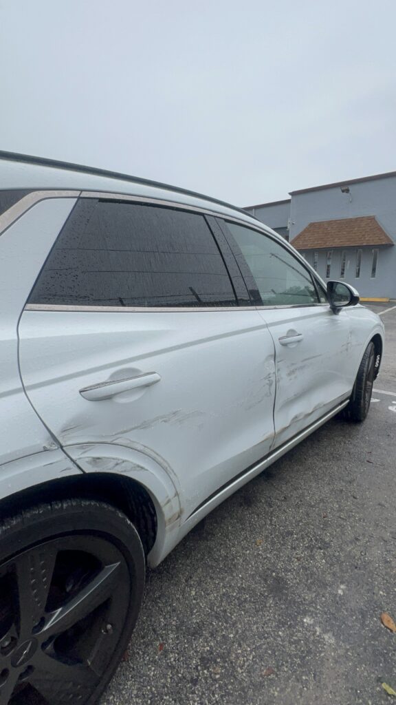 Car with damaged side panel prepped for aluminum welding and bodywork restoration at Primo Paint & Body
